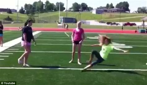 Oops... Cheerleader's knock-out fail as she accidentally kicks herself ...