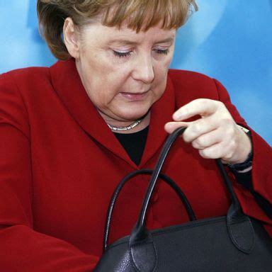 Angela Merkel Loves Rummaging Through Her Enormous Handbag