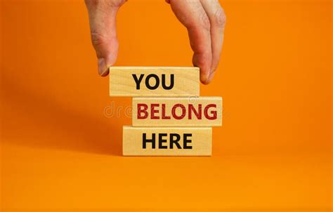 You Belong Here Symbol. Wooden Blocks with Words `You Belong Here` on Beautiful Orange ...