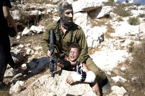 Israeli soldier putting Palestinian boy in a headlock during protest ...