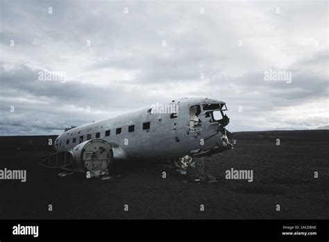 Abandoned airplane in black sand desert Stock Photo - Alamy