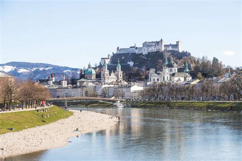 Salzburg spring time: Panoramic city landscape with Salzach with green grass and historic ...