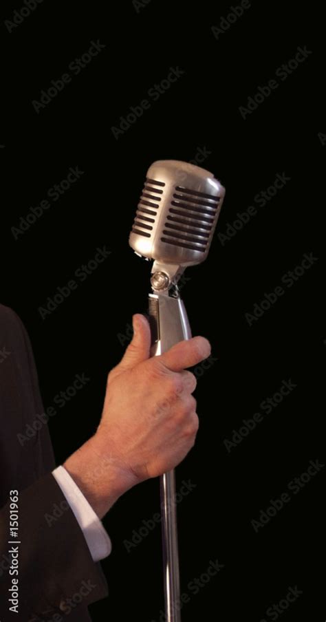 singer holding vintage microphone & stand Stock Photo | Adobe Stock