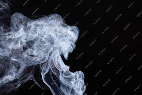 Premium Photo | Abstract white flowing smoke clouds on black background