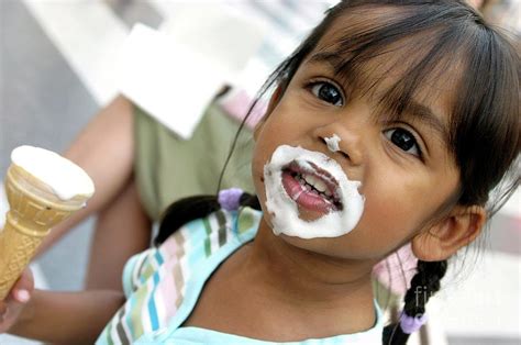 Young Girl Eating An Ice Cream Photograph by Claire Deprez/reporters/science Photo Library