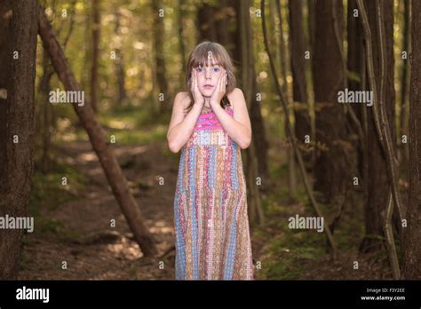 Lost little girl in the forest Stock Photo - Alamy