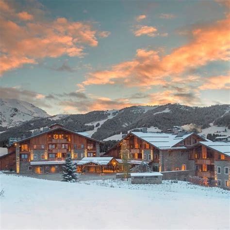 Four Seasons Hotel Megeve lodge with lights on snow-covered mountain at sunset | Ski hotel ...