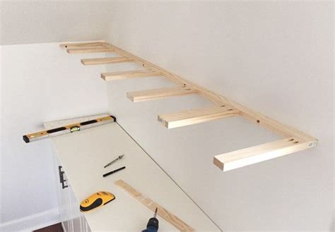 Brace piece of DIY thin wood floating shelves hung on a wall using 1x3 ...