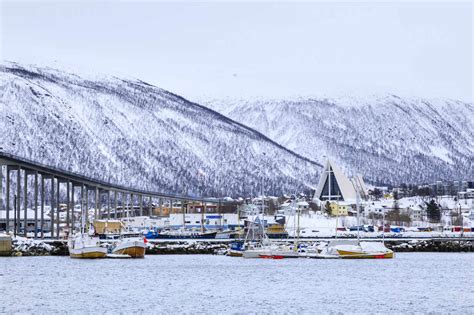 Tromso, small boat harbour, fjord, bridge, Arctic Cathedral, deep snow in winter, Tromso, Troms ...