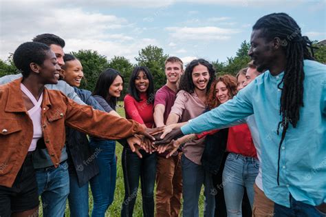 Premium Photo | Multicultural group of young friends having a fun time together outdoors