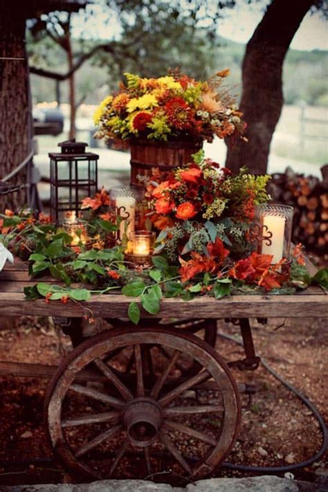 a wooden table topped with lots of flowers and candles next to a fire hydrant