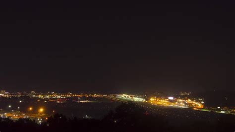 Night footage of aviation traffic at the airport. Landing lights illuminate the runway 26332640 ...