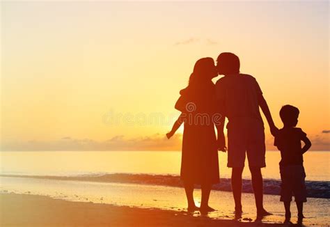 Romantic Kissing Couple with Kids at Sunset Stock Photo - Image of ...