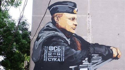 'Your Move': Graffiti On Putin Mural In Crimea Taunts FSB