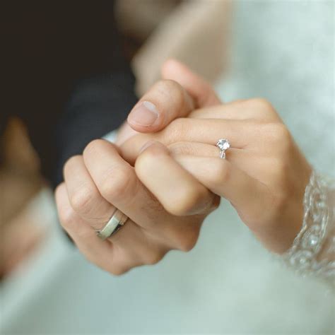 The couple holding hands together. They had a wedding rings wear | Shop Engagement Rings and ...