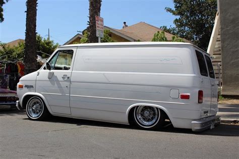 White Van Parked Next to a Red Car