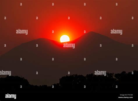 Sun setting over forest hi-res stock photography and images - Alamy