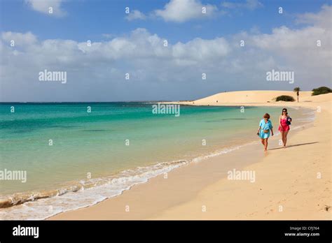 Praia de Chaves, Boa Vista, Cape Verde Islands. Two women walking along ...