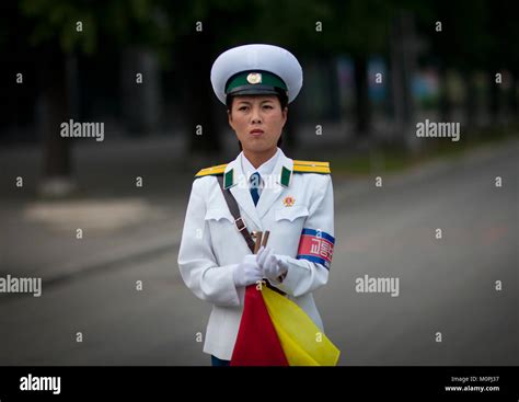 North Korean female traffic security officer in white uniform in the ...