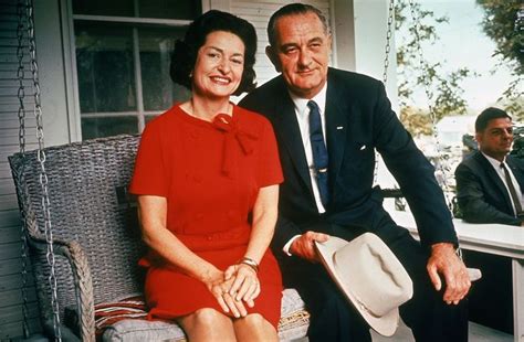 President Lyndon Johnson sitting on porch swing with wife Claudia (Lady Bird) on the morning ...