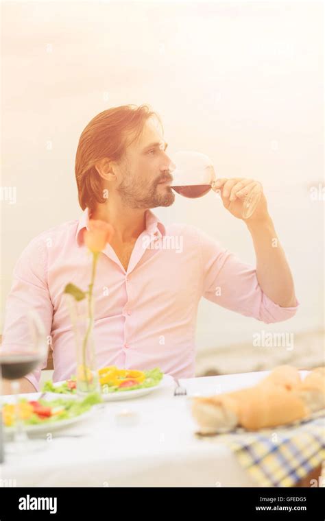 Handsome man drinking wine Stock Photo - Alamy