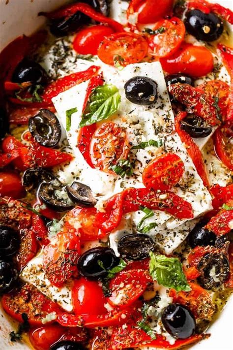 baked feta cheese blocks topped with tomatoes, olives, peppers, and herbs Cheesy Dip Recipes ...