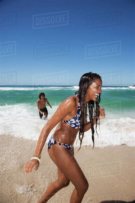 Woman laughing on tropical beach - Stock Photo - Dissolve