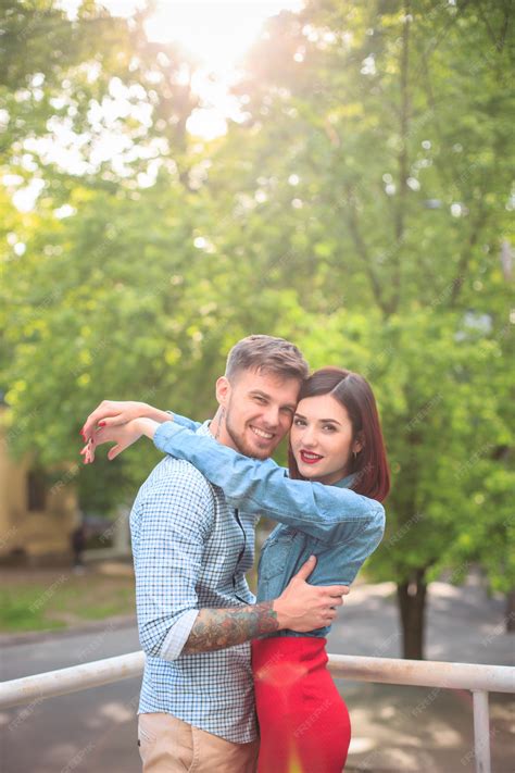 Free Photo | Happy young couple at park standing and laughing on the ...