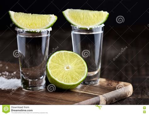 Tequila Silver Shots with Lime Slices and Salt on Wooden Board Stock Photo - Image of cocktail ...