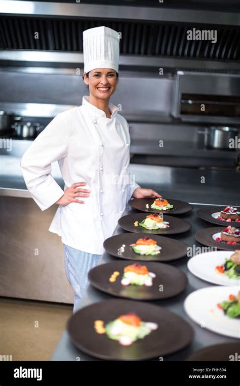 Happy chef with her dishes Stock Photo - Alamy