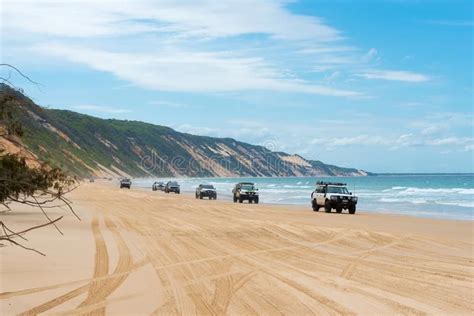 4wd vehicles at Rainbow Beach with coloured sand dunes, QLD, Australia ...