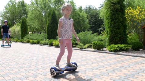 Children ride on a Segway motorized scooters hoverboard in the park Stock Video Footage ...