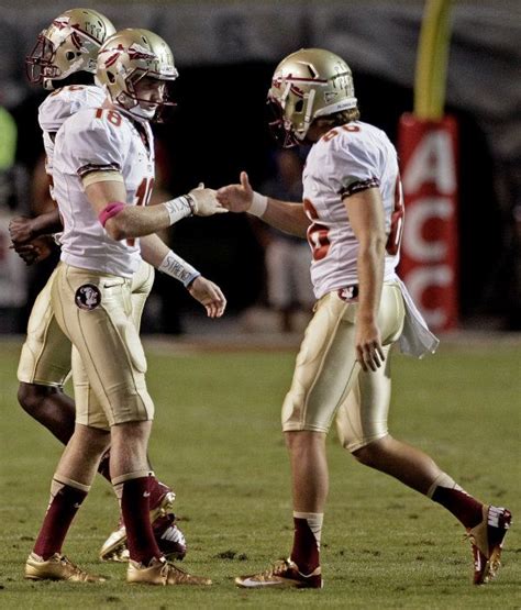 Florida State kicker Dustin Hopkins (18) is congratulated by Chris ...