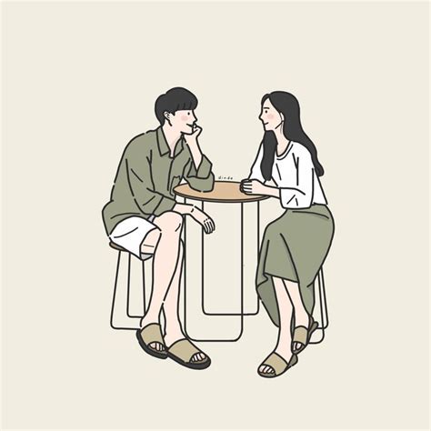 two people sitting at a table talking to each other, one is holding a cup