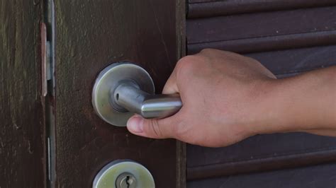 Close up of woman hand opening a door. Wooden door with chrome metal handle 8078404 Stock Video ...