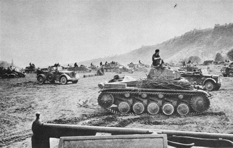 an old black and white photo of tanks in the dirt