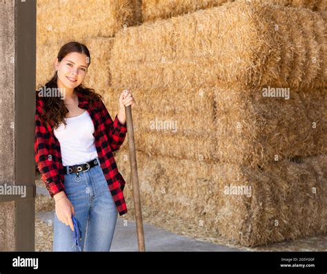 Female farmer posing on hayloft at cow farm Stock Photo - Alamy