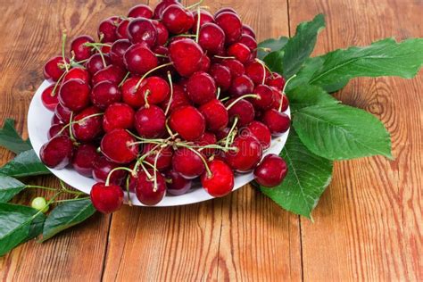 Sweet Cherries with Stalks on Dish, Leaves on Rustic Table Stock Image - Image of stem, vitamin ...