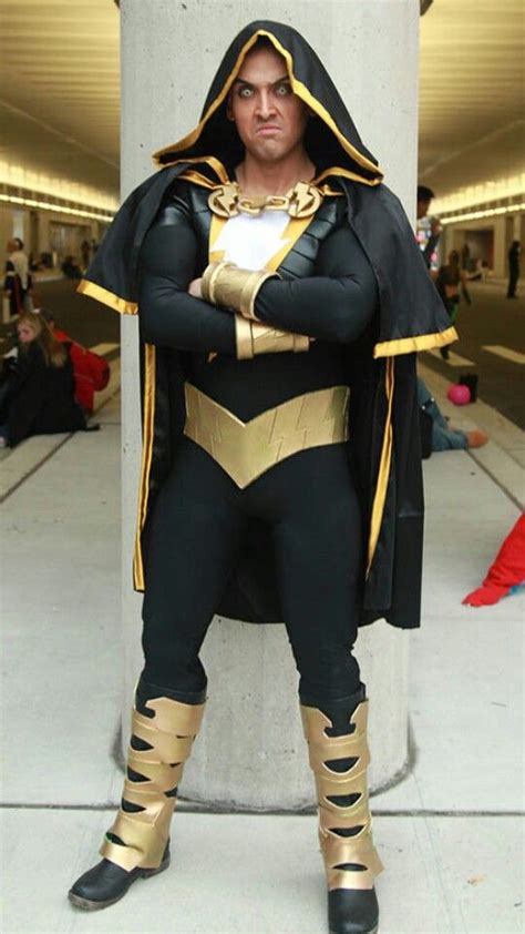 a man dressed in costume standing next to a pillar with his hands on his hips