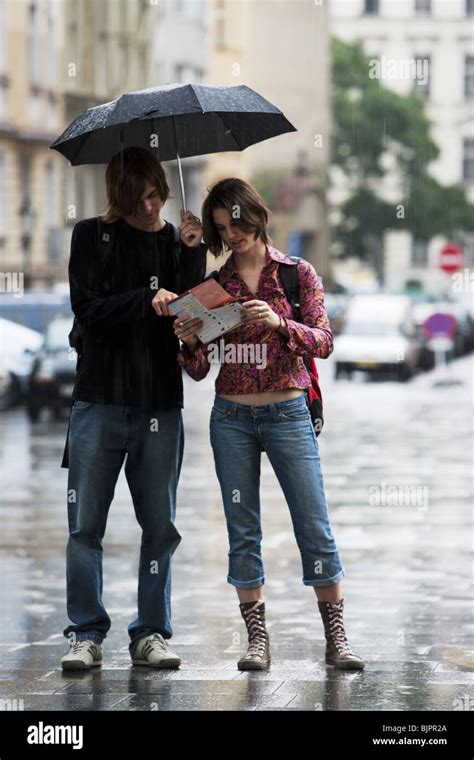 Couple with umbrella in the rain Stock Photo - Alamy