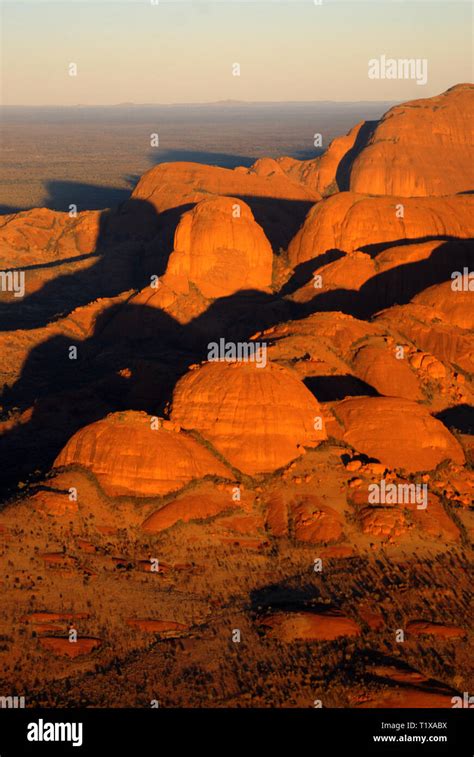 A portrait aerial view of sunrise over the Kata Tjuta rock formation in ...