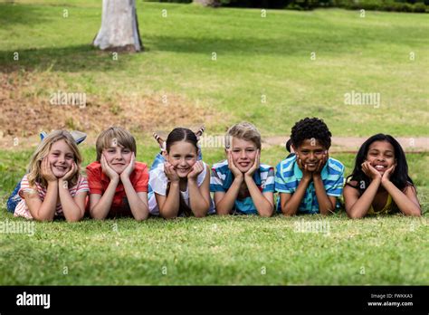 Happy children lying on grass Stock Photo - Alamy