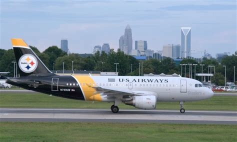 US Airways' plane in Steelers (former Pittsburgh hub) livery in front ...