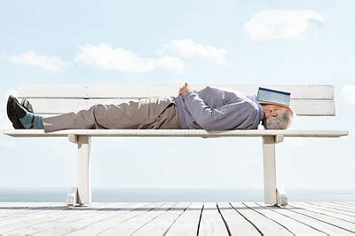 Old man sleeping on the bench with book on his face - Stock Image ...