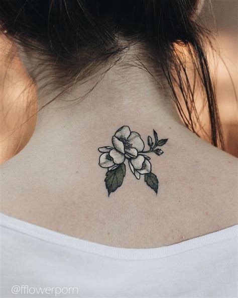 Jasmine tattoo on the back of the neck.