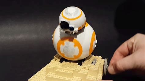 a lego star wars bbg droid toy being held by someone's hand