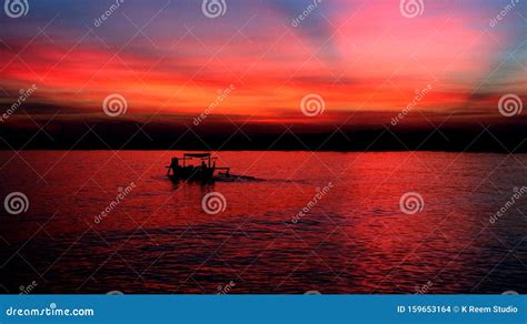 The Sunset with the Silhouette of a Fishing Boat Stock Photo - Image of ...