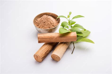 Premium Photo | Chandan or sandalwood powder with sticks and green leaves