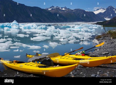 Kayaking in Bear Glacier Lagoon, Kenai Fjords National Park, near Seward, Alaska. (model ...