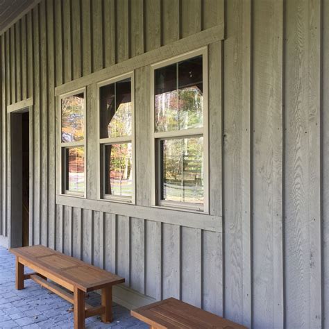 Barn with board and batten siding, front porch, benches, gray green hemlock and vinyl windows ...